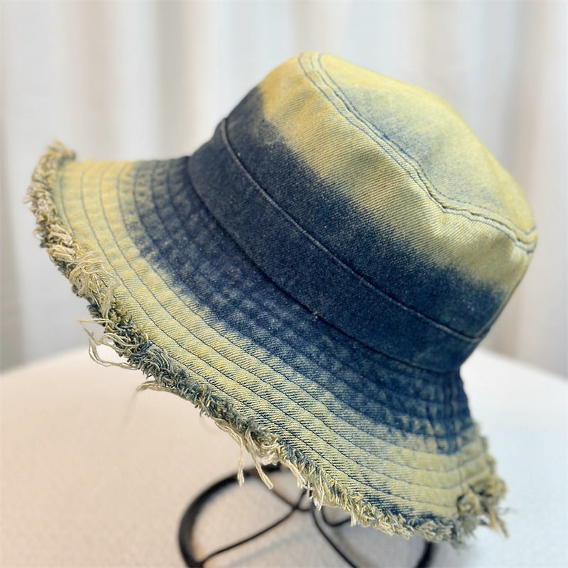 Denim bucket hat with yellow-and-blue wash and frayed wide brim