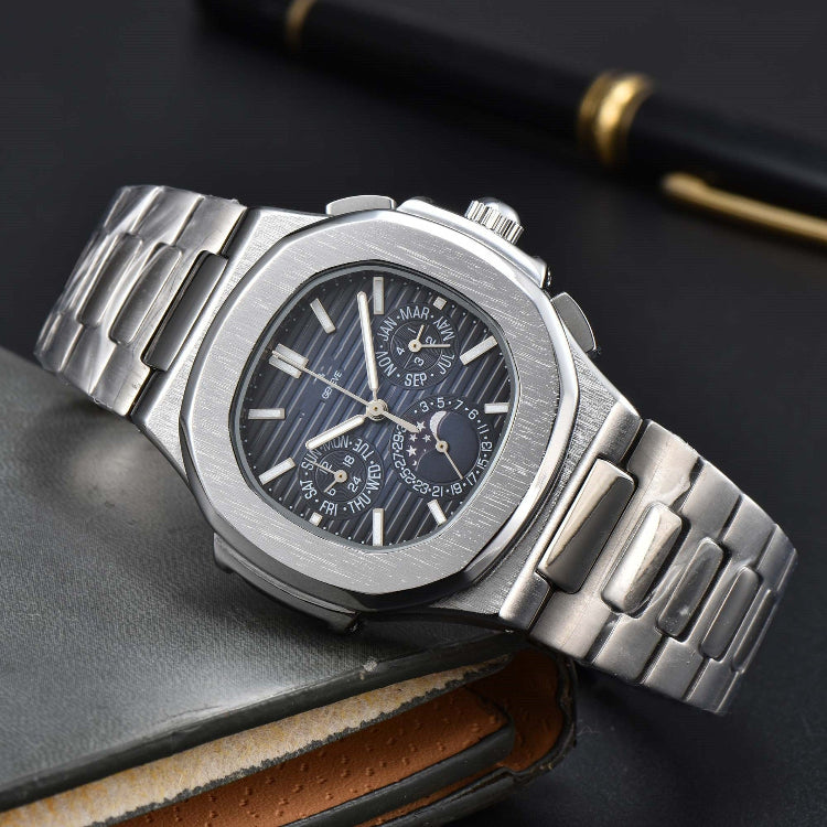 Silver wristwatch with detailed face on a dark surface