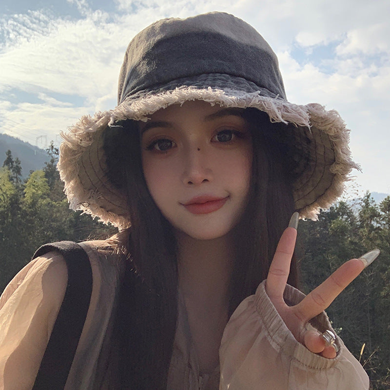 Black denim bucket hat with frayed wide brim and soft stitched crown