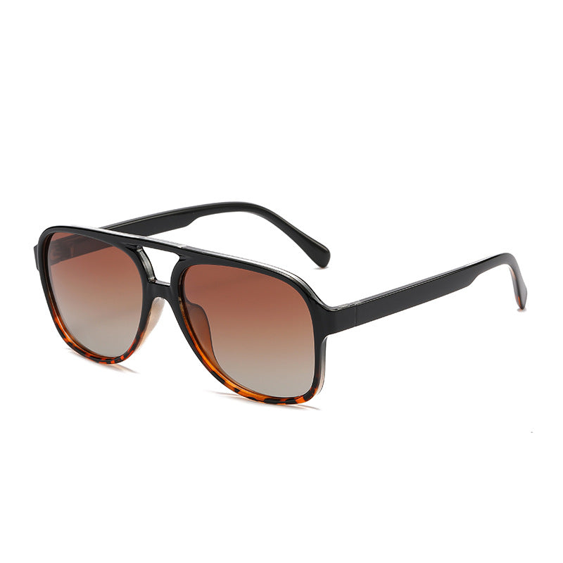 Unisex polarized sunglasses with black full-rim frames and brown gradient lenses