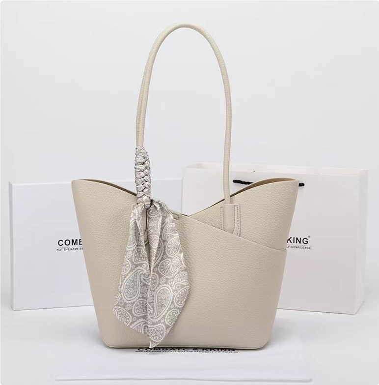 White shoulder handbag with textured finish and patterned fabric bow tie