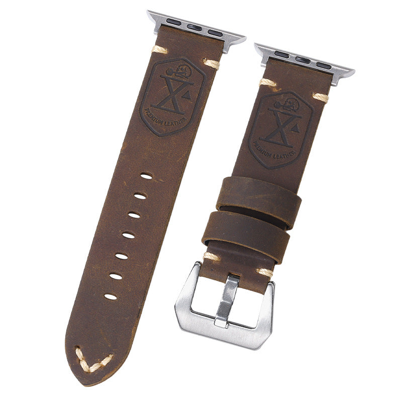 Dark brown leather watch straps with embossed shield logo, silver buckles, and perforations