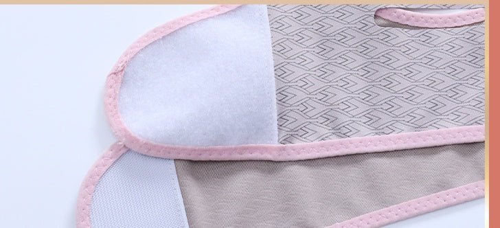 Close-up of the mask’s patterned fabric, pink edging, and overlapping fastening flap