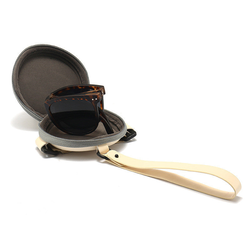 Tortoiseshell polarized folding sunglasses with dark lenses, open case included