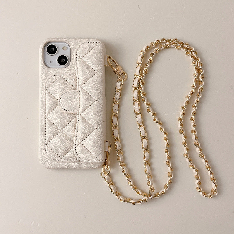 Quilted phone case with gold chain on a beige background