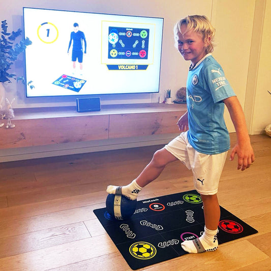 Training mat with soccer ball icons; child practices footwork indoors