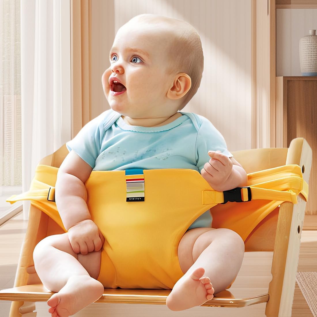 Yellow baby seat belt fitted to a high chair, with a wide front panel and adjustable side straps.