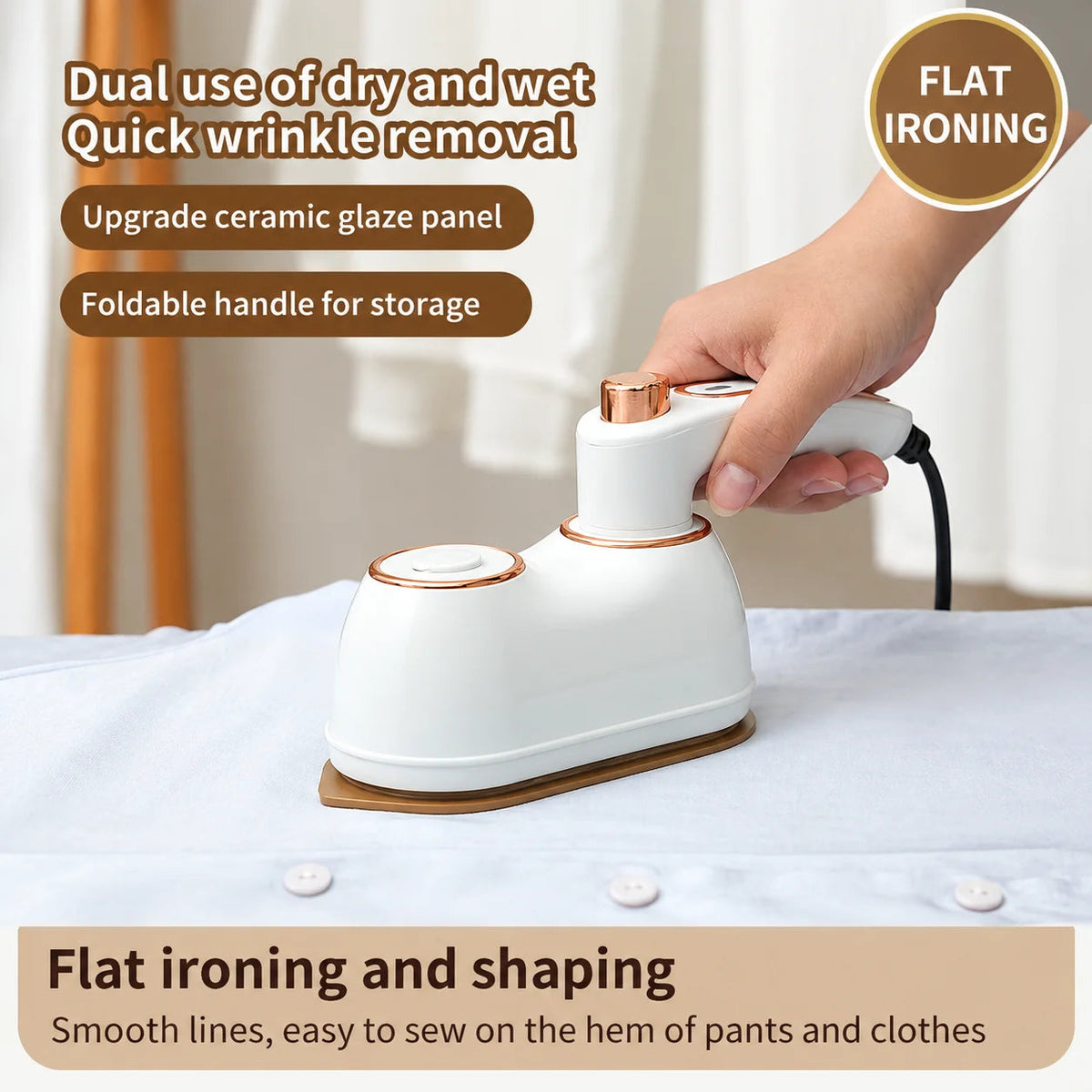 Portable folding clothes iron with foldable handle pressed against flat fabric