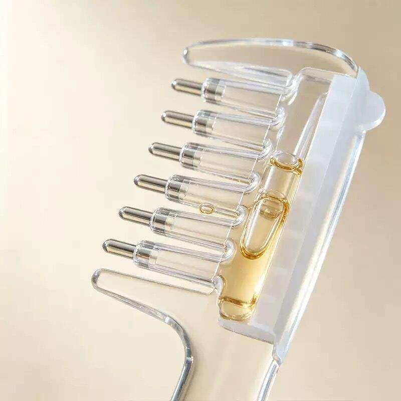 Close-up of clear applicator comb teeth with metal rollers and a liquid-filled reservoir.