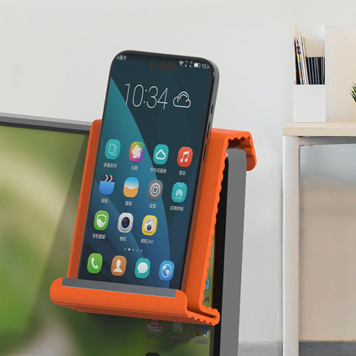 Orange phone stand holds a smartphone in portrait orientation.