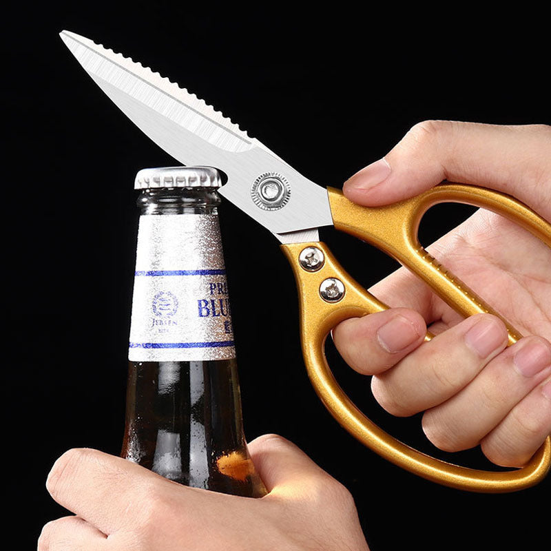 Gold-handled kitchen scissors used to pry off a bottle cap.