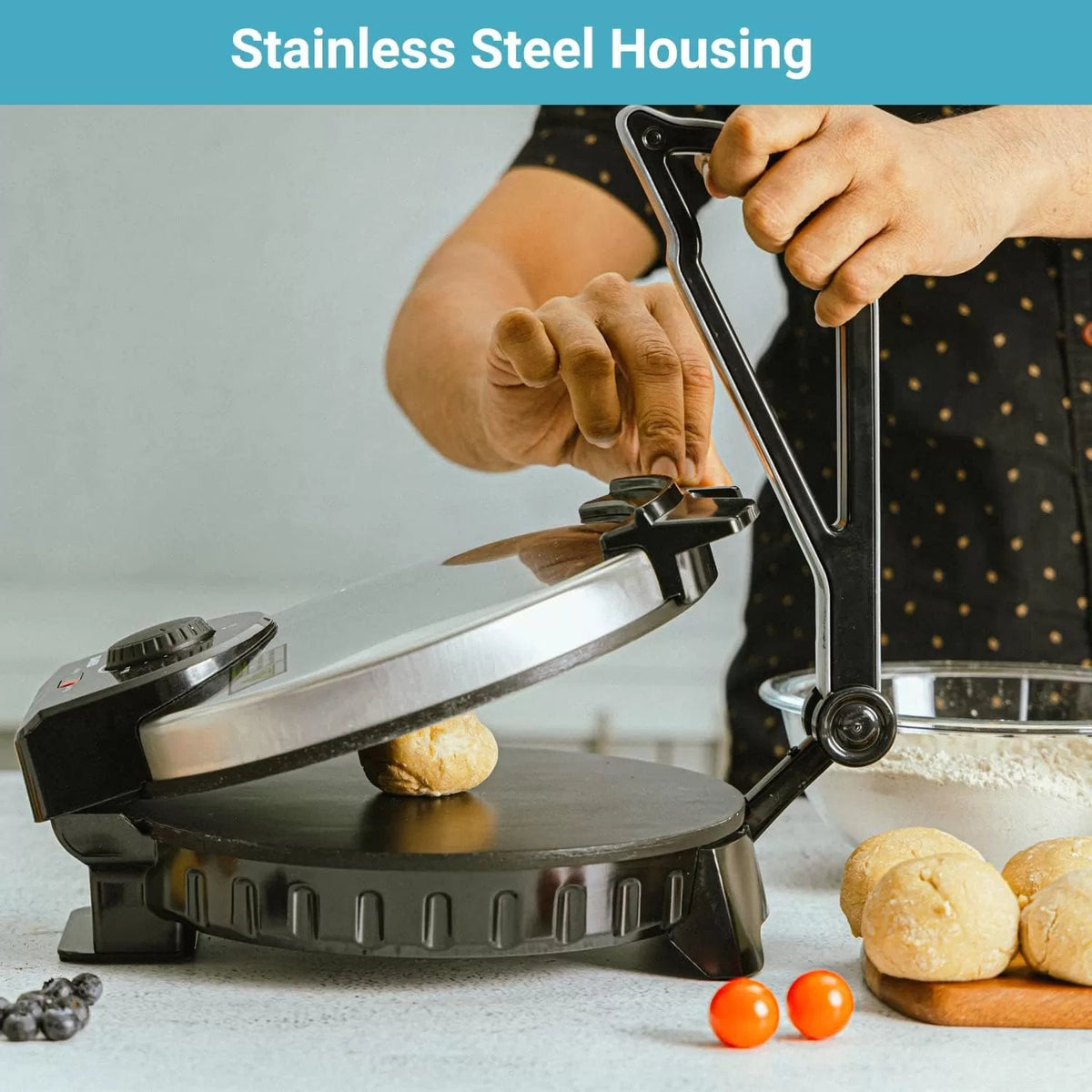 Electric roti maker with stainless steel lid lifted above the black cooking plate