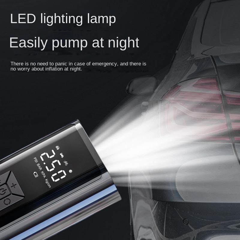 Digital air compressor with a built-in LED light illuminating a car tire.