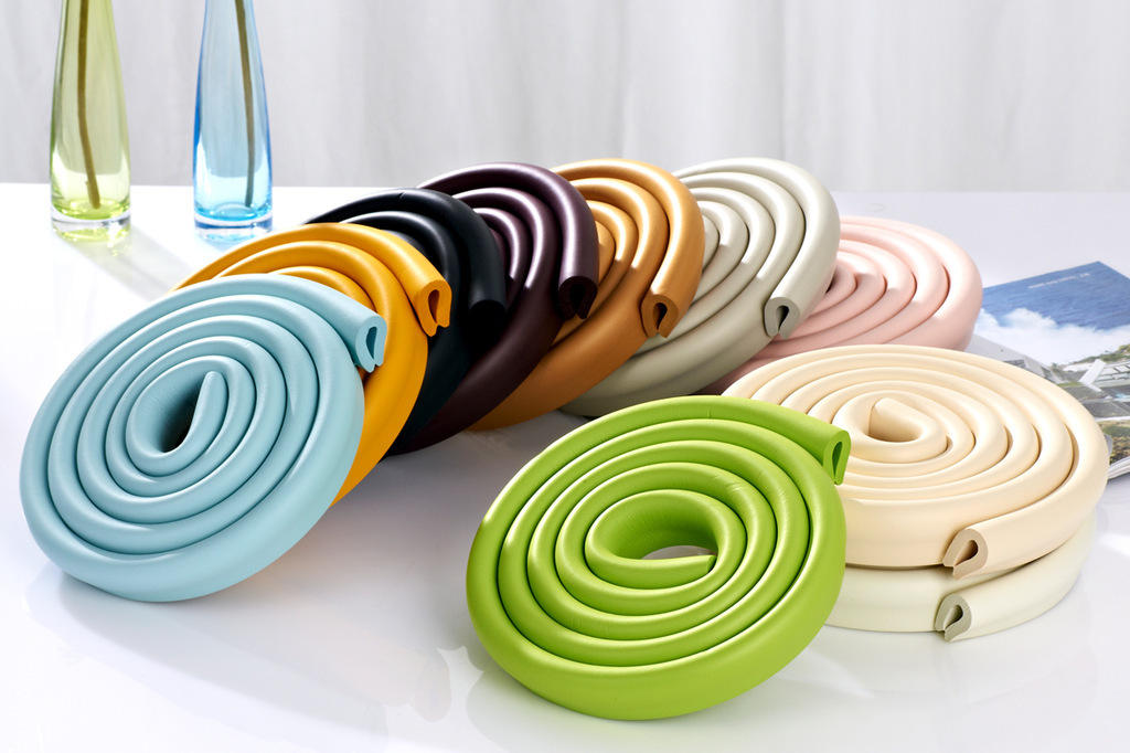 Rolled foam edge guards in assorted colors, including blue, green, and cream