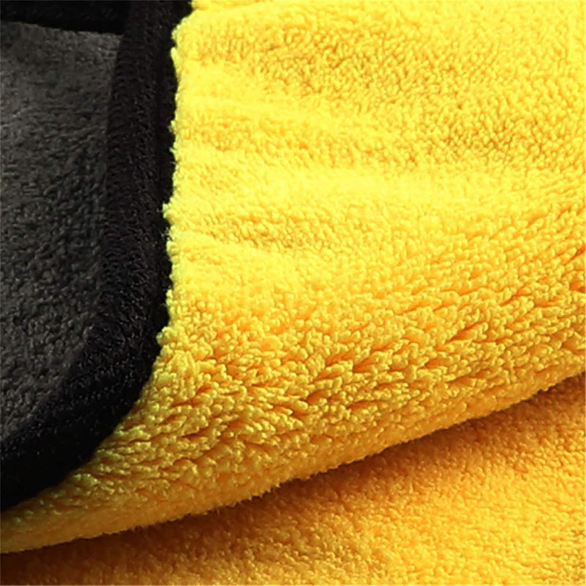 Close-up of yellow microfiber pile, gray reverse, and black edging