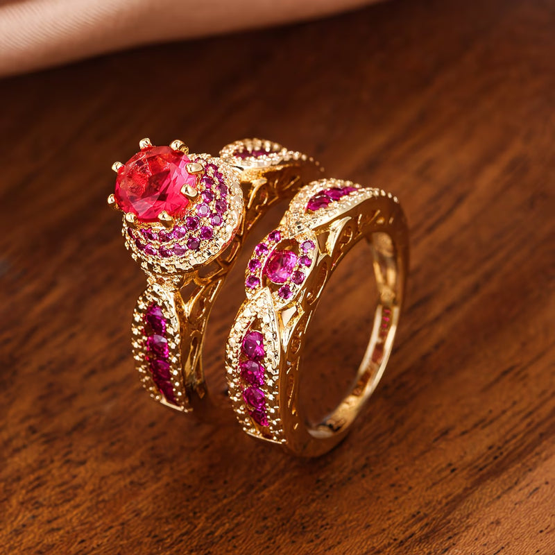 Gold zircon-inlaid women's ring with red center stone and pink ruby-like accents.