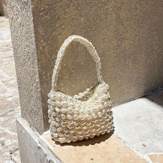 White pearl-beaded woven handbag with top handle and scalloped beaded trim