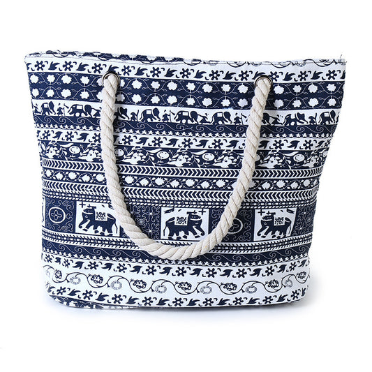 Navy blue and white patterned tote bag with rope handles on a white background