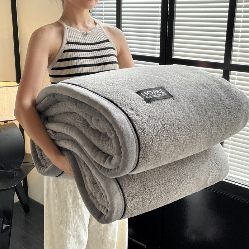 Velvet solid charcoal-gray blanket rolled, plush pile with HOME label and dark trim