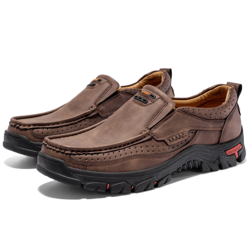 Pair of brown leather shoes with black soles on a white background