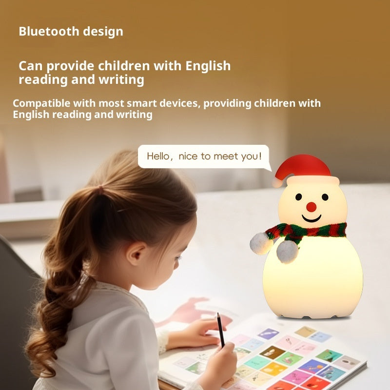 Glowing snowman night light with red hat and green scarf, standing on small base