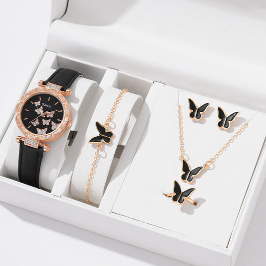 Jewelry set with a watch, bracelet, and necklace featuring butterfly designs in a white box.