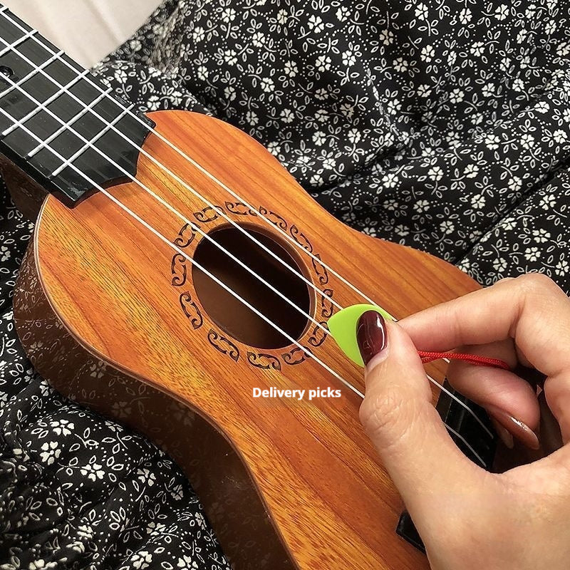 Kids wooden 4-string ukulele toy held by hand; close-up of sound hole and strings