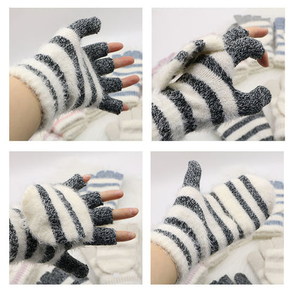 Pair of black and white striped gloves worn on hands with a light background.