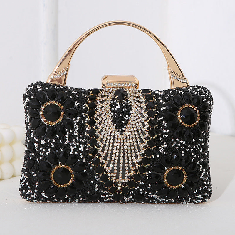 Handmade diamond clutch bag in black with crystal flower accents, gold-tone handle