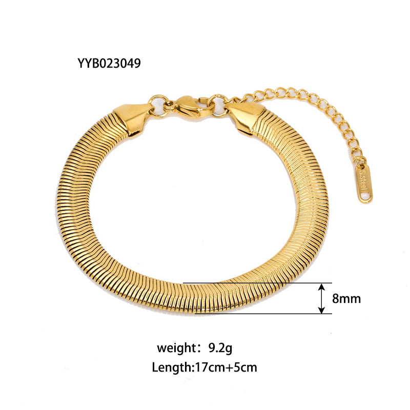 Gold-tone ribbed coil bracelet with clasp and small chain end