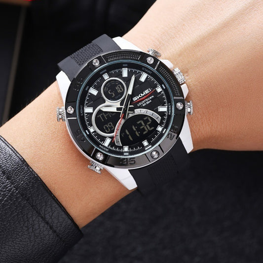 Black and silver watch on a wrist with a blurred background