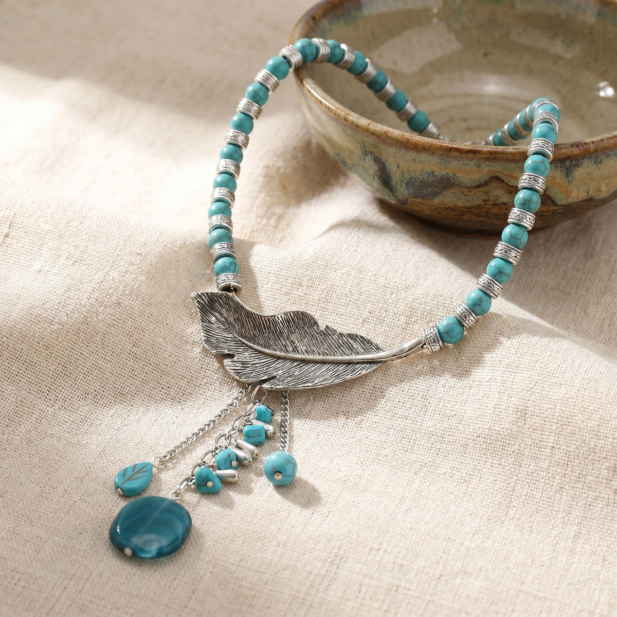 Turquoise bead choker necklace with alloy feather pendant and round blue drop charms