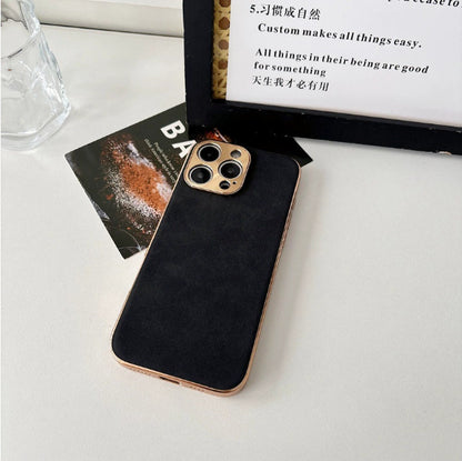 Black phone case with gold camera ring on a white surface
