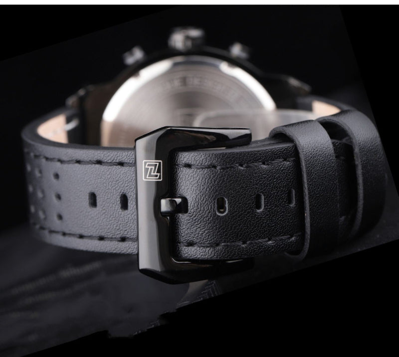 Close-up of a black leather watch strap with a buckle on a dark background