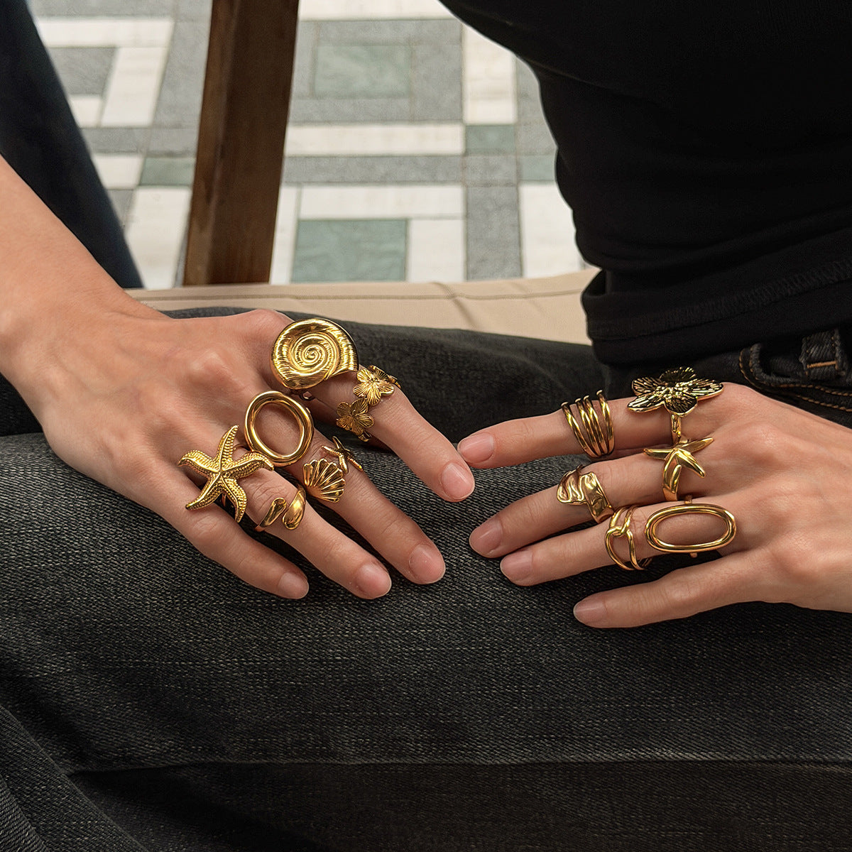 Gold 18K vacuum-plated spiral ring on finger with stacked band detail