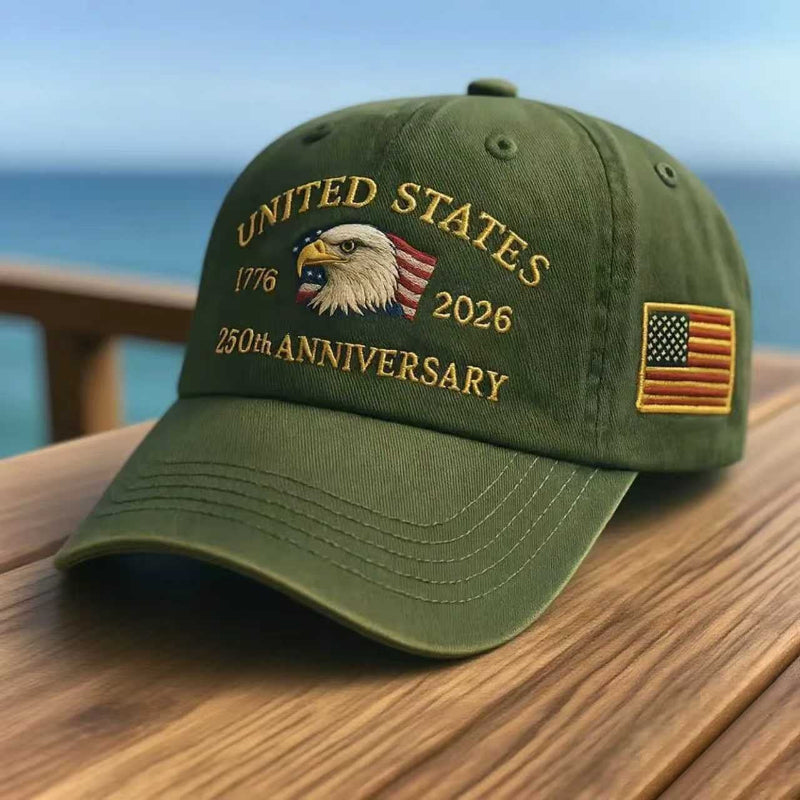 Army green washed-print cap with gold “United States 1776–2026” and eagle graphic.