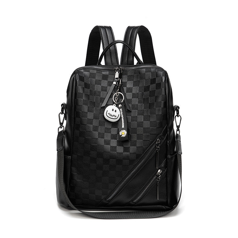 Black checkered backpack with a keychain on a white background