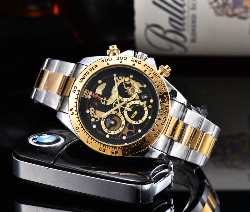 Men's quartz watch with steel link strap, black dial, gold-tone bezel and accents.