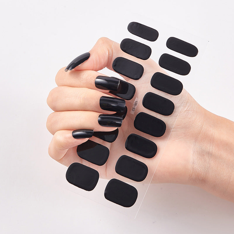 Hand with black nail wraps on a white background