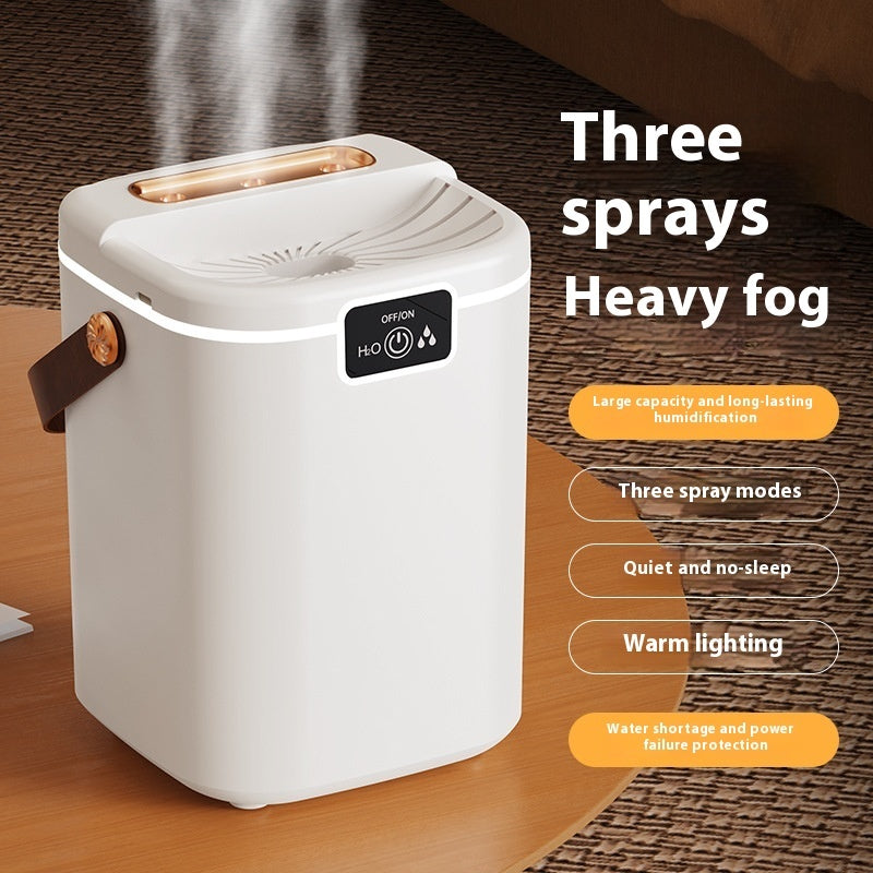 White desktop humidifier with three-spray top outlet and warm lighting