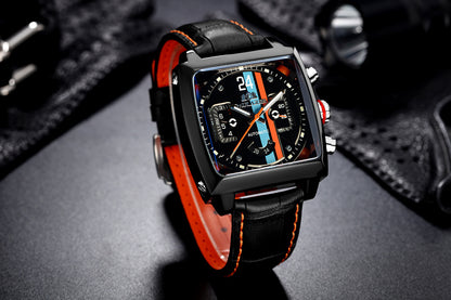 Luxury watch with black and red strap on a dark surface