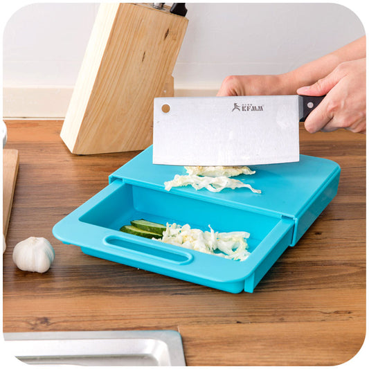 Person using a blue vegetable chopper with a knife on a wooden countertop.