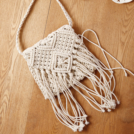 Macrame bag with fringes on a wooden surface
