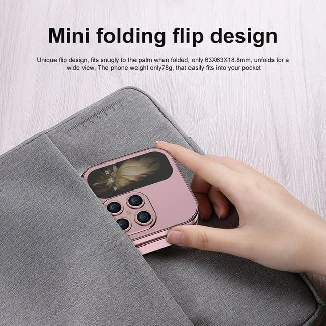 Pink folding flip phone held in a hand, with flip cover and rear camera module visible
