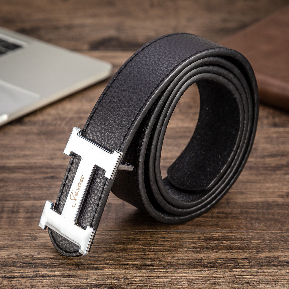 Men's black leather belt with silver buckle and stitched textured finish, close-up.