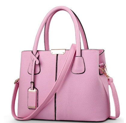 Light pink leather shoulder tote bag with gold-tone hardware and top handles