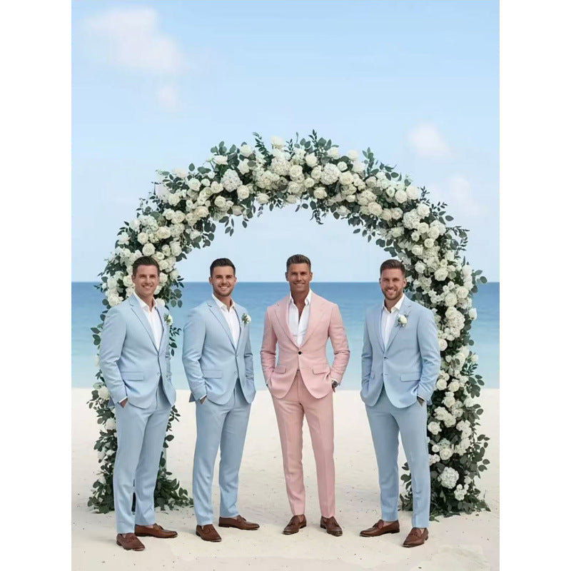 Four men wearing pale pink and light blue two-piece suits with matching jackets and trousers