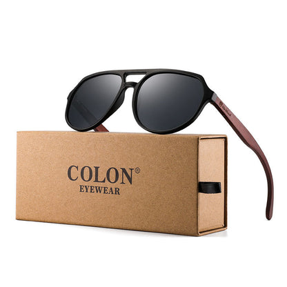 Aviator sunglasses with brown frame and dark lenses on a Colon Eyewear box.