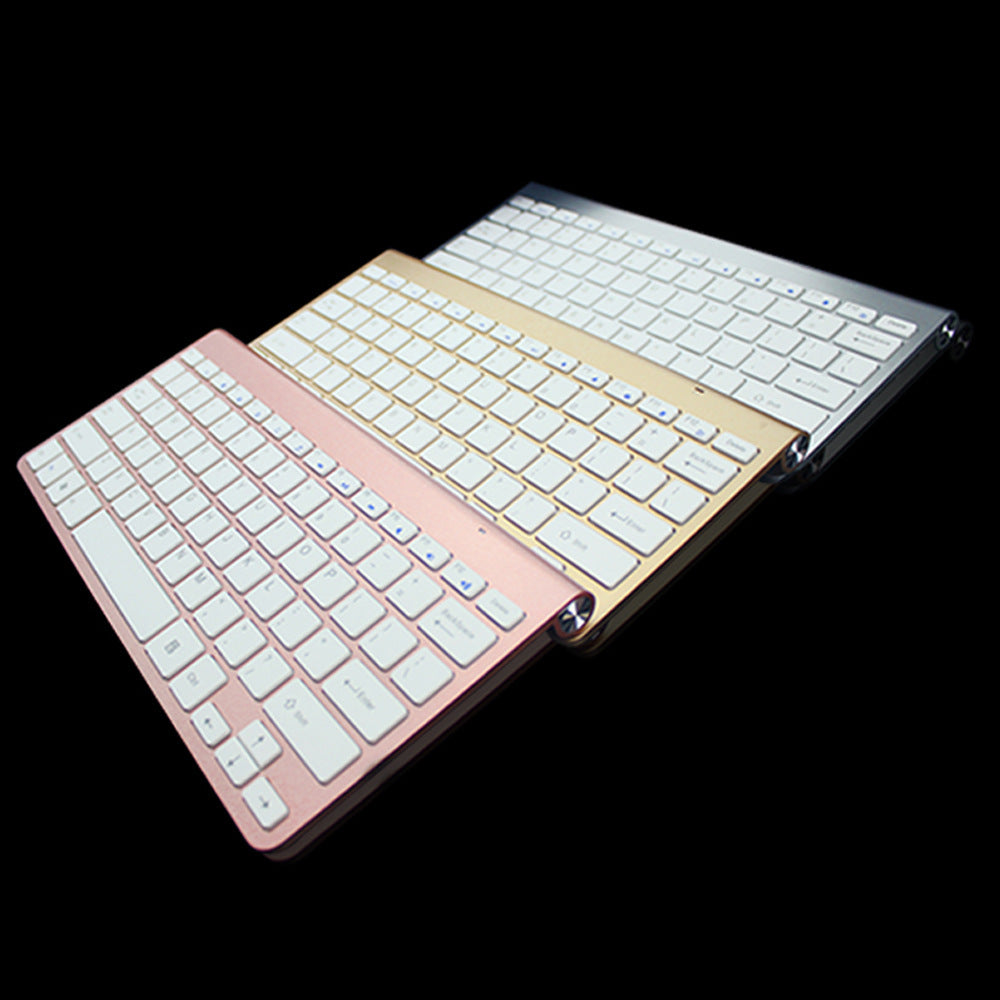 Two keyboard covers, one gold and one rose gold, on a black background.