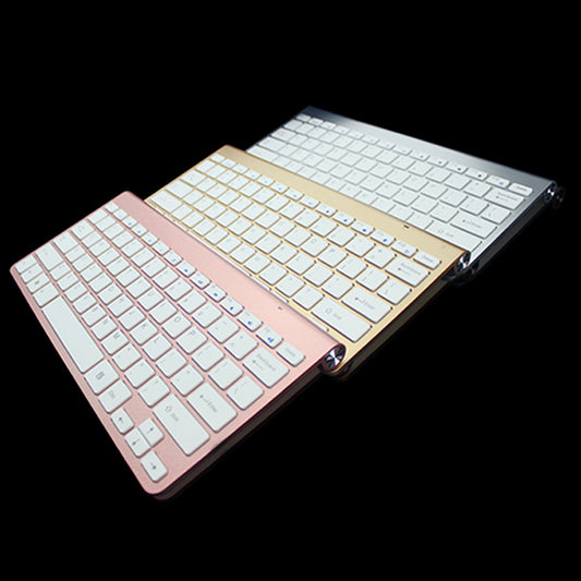 Two keyboard covers, one gold and one rose gold, on a black background.